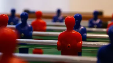 Close-up of the players on a foosball table
